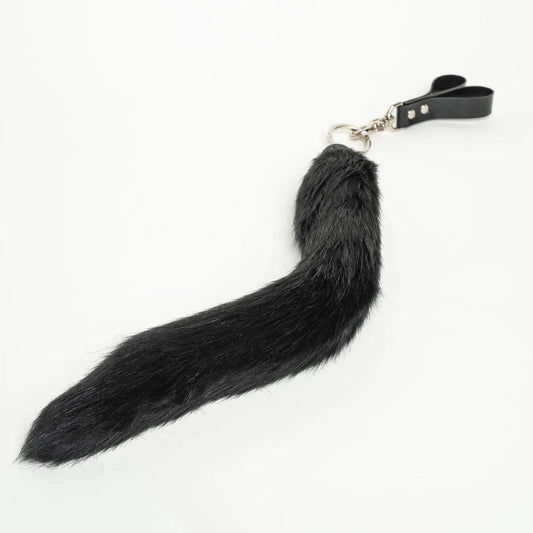 Black faux fur tail finger flogger on a white background