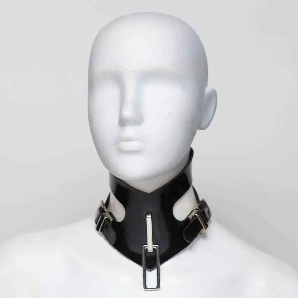 Black rubber choker on a mannequin head against a white background