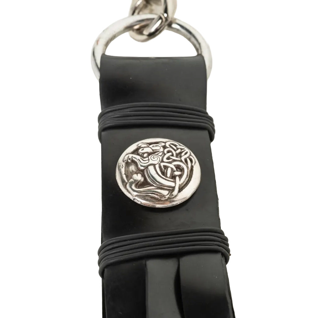 Black rubber strap with silver Celtic knot design on a white background