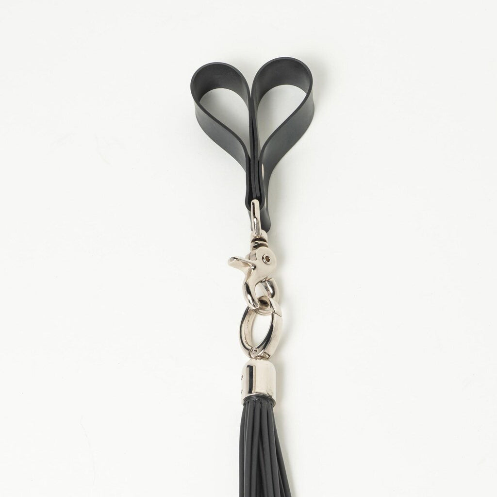 Black rubber finger loop clip with a silver clasp and black tassel on a white background