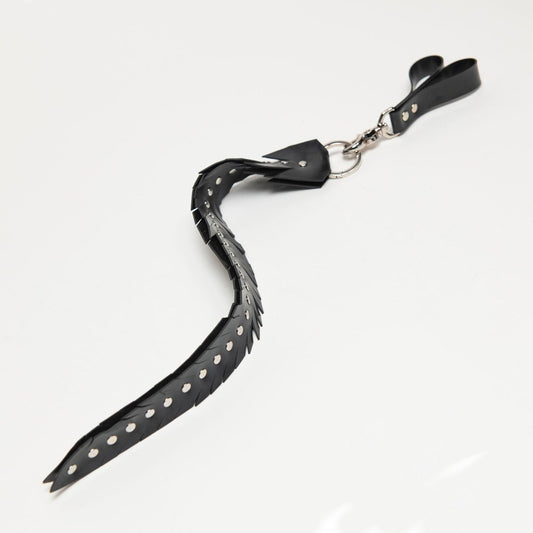 Black feathered edge strap with studded details on a white background