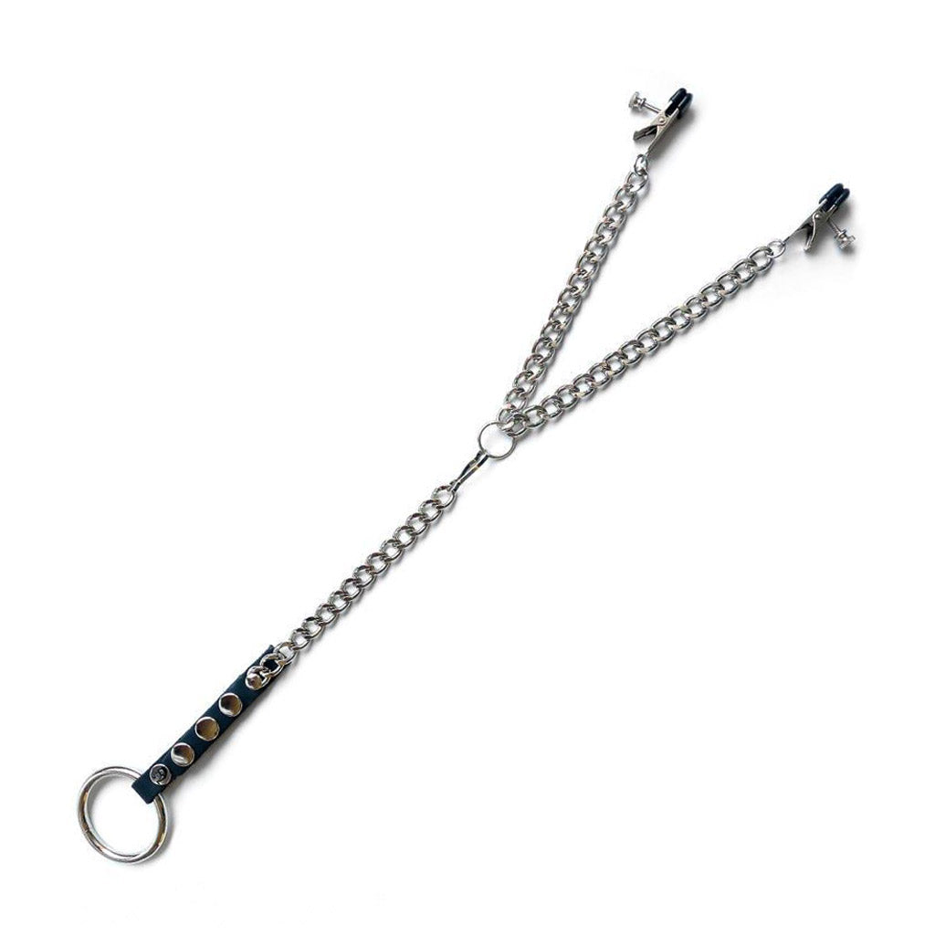 The Nipple Clamps/Cock Ring Set is displayed against a blank background. The silver clamps are attached to a Y-shaped chain, which connects to a leather strap with a metal cock ring at the bottom.