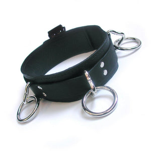 The 3-Ring Slave Collar With A Locking Buckle is shown against a blank background. It has three metal triangle rings, each one with an O-ring attached to it. There is a smaller triangle ring attached to a tab at the back of the collar.