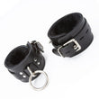 Load image into Gallery viewer, A pair of black Premium Fleece-Lined Leather Cuffs With A Locking Buckle is displayed against a blank background. The cuffs have a lockable metal buckle and a metal triangle, which has an O-ring dangling from it. The cuffs are lined with black fleece.