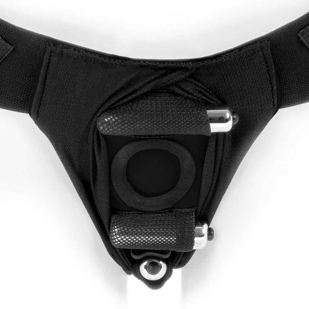 View of a black SpareParts Joque Dildo Harness from the back, showing two bullet vibes inserted above and below the opening.