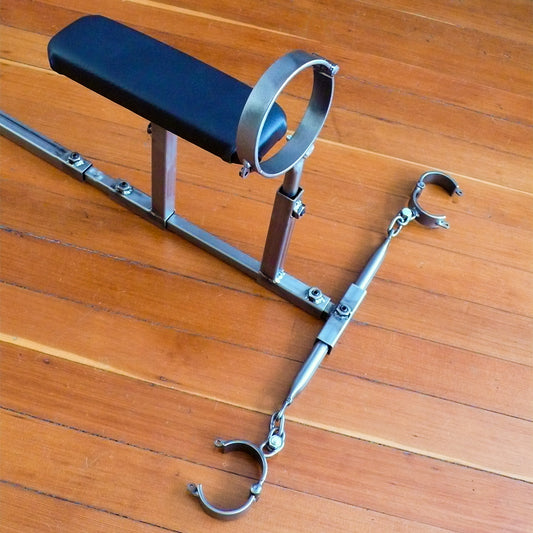 The upper half of the Stockroom Stockade, positioned on a wooden floor, is shown. The black leather pad for support is positioned upright near the collar.