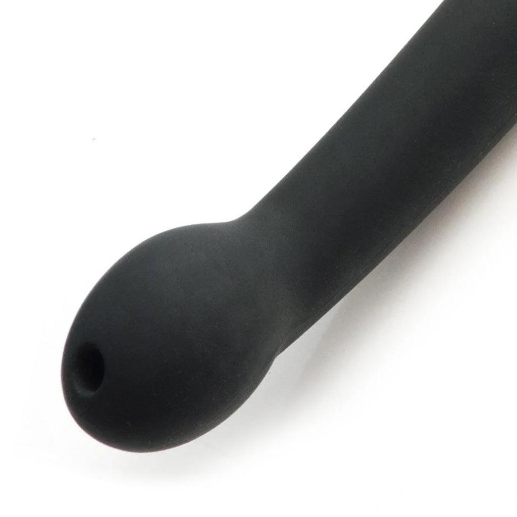 A close-up of the bottom of the handle of the Tantus Plunge Paddle is shown against a blank background. The handle has a curved, bulbous end, which has a small hole at the top.