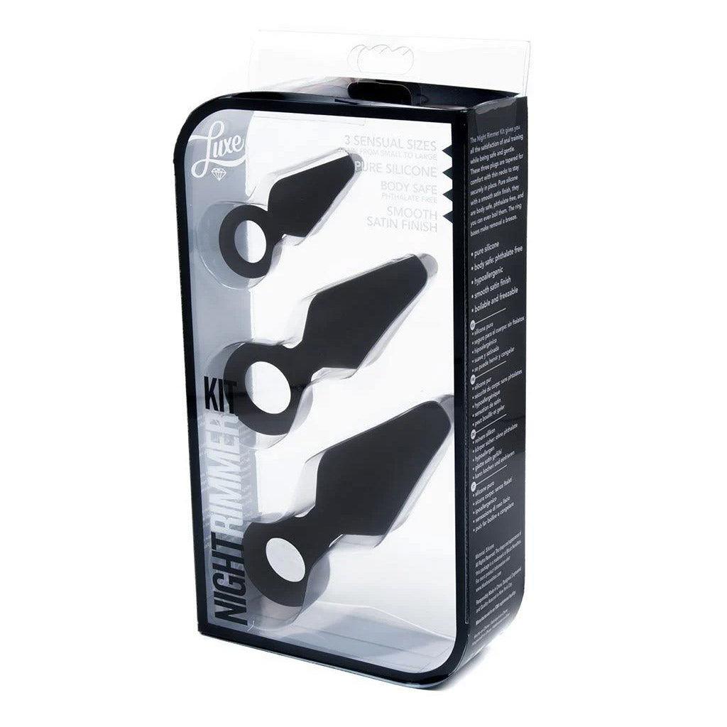 A set of black silicone butt plugs, shown in a transparent plastic package.