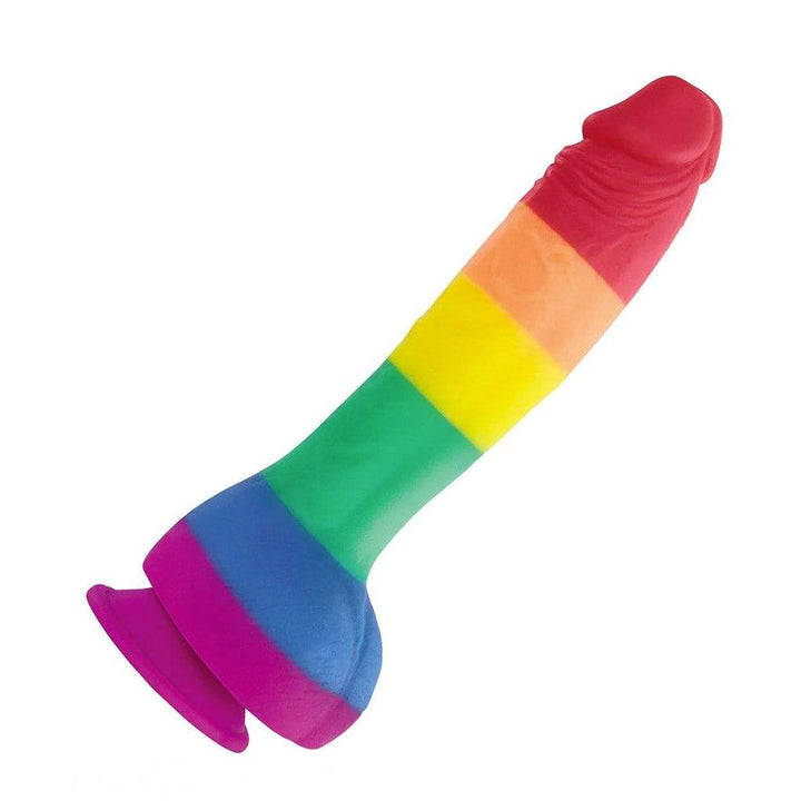 The 6” Colours Pride Edition Silicone Dildo is displayed against a blank background. The dildo is shaped like a realistic penis with balls and has a suction cup base. The dildo is rainbow-colored, with red at the tip and purple at the base.