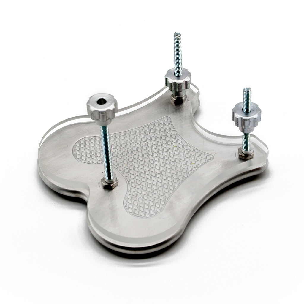 The Extreme CBT Ball Crusher is shown assembled with the metal and acrylic plates on top of each other and the nuts partially screwed onto the bolts.