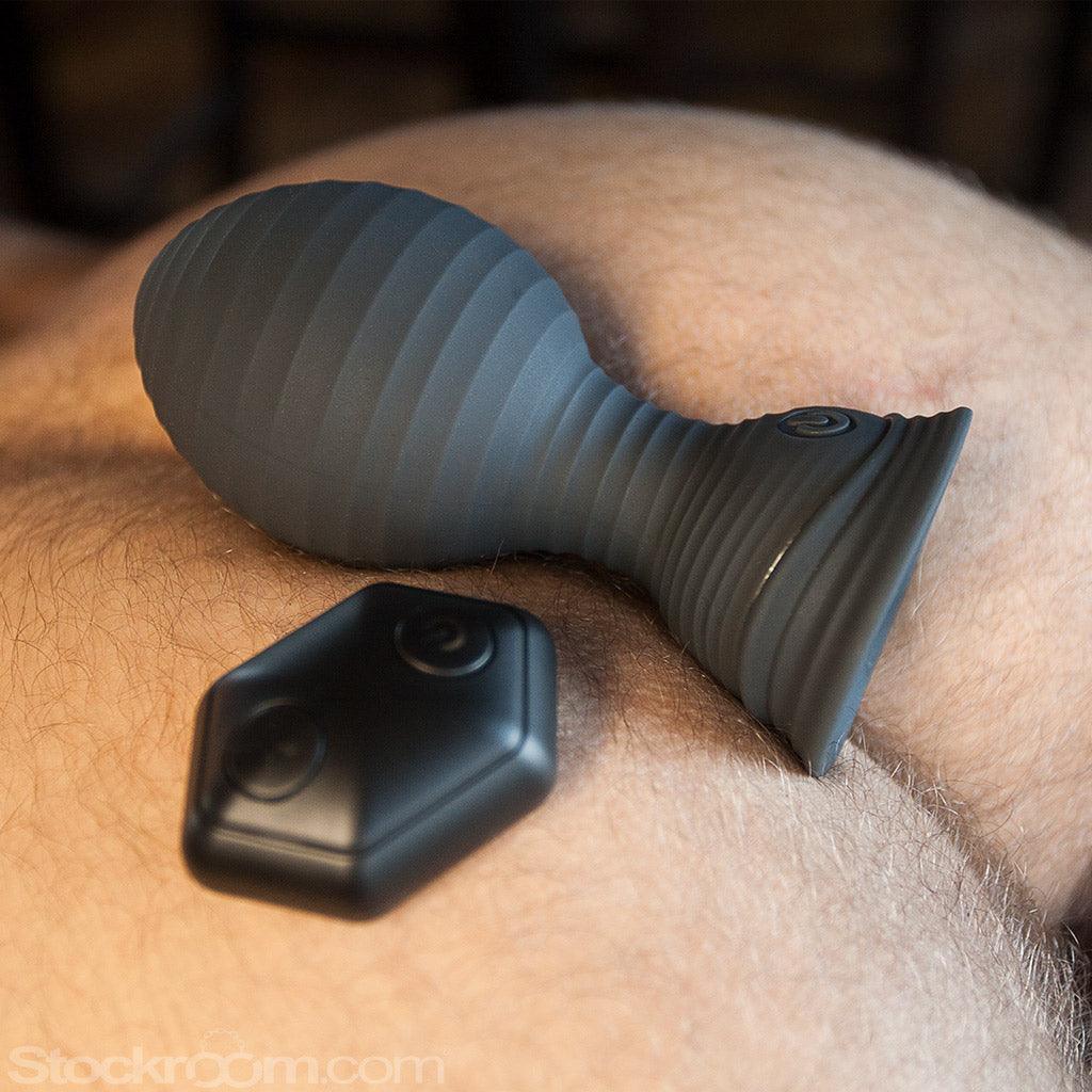 A man's bare bottom, with a VIP vibrating butt plug (with remote) sitting just on top of the crack.