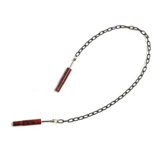 The red Extreme Talon Nipple Clamps are shown against a blank background. The clamps are dark red cylinders with the edges retracted into them. They are attached by a silver chain link.