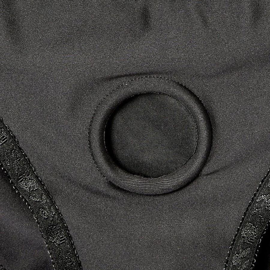 A closeup of the Em.Ex. Silhouette Crotchless Strapon Harness, showing the fabric-covered O-Ring.
