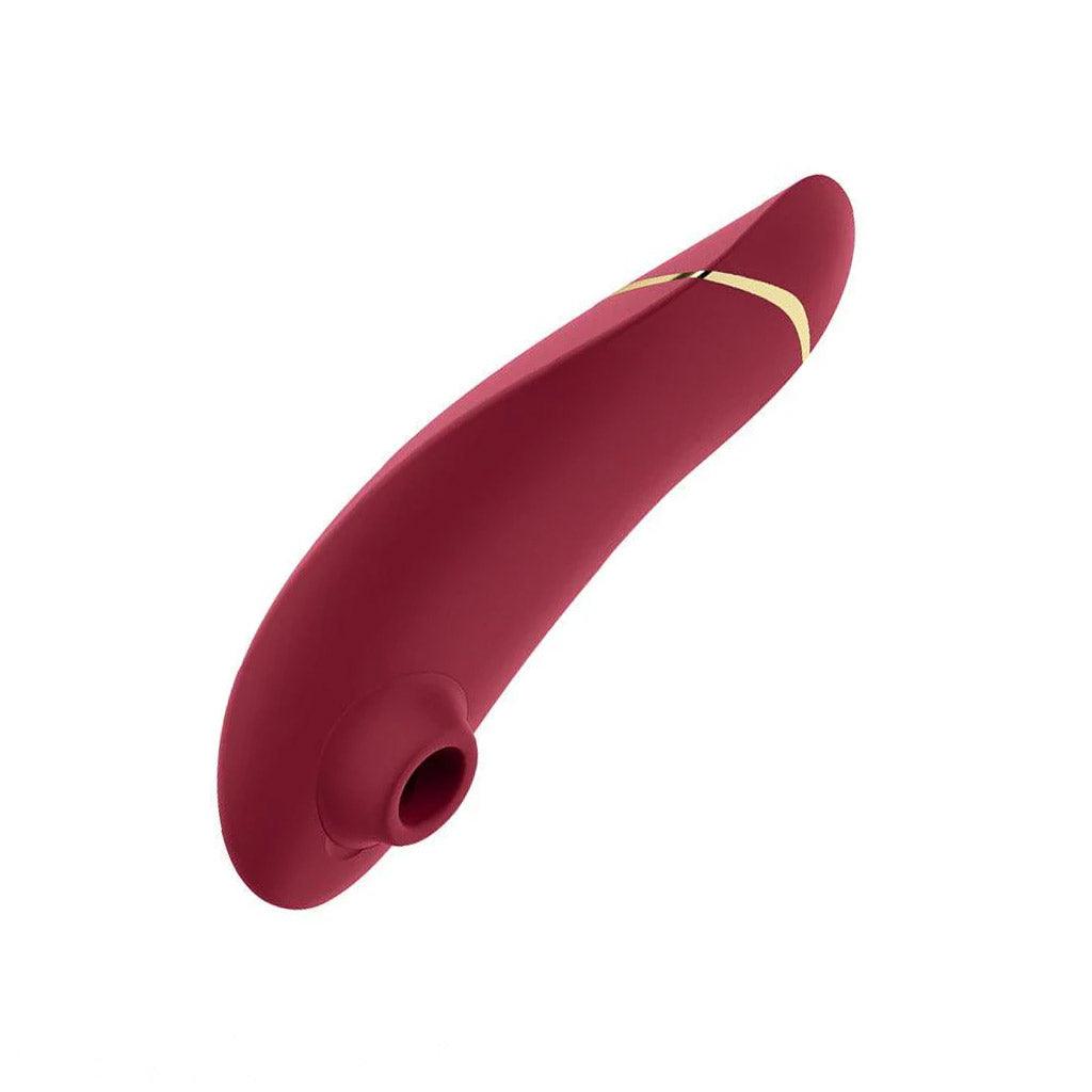 The Womanizer Premium 2 Vibrator in bordeaux red color, shown on a white background. It is seen from the front, so the suction point can be seen clearly.
