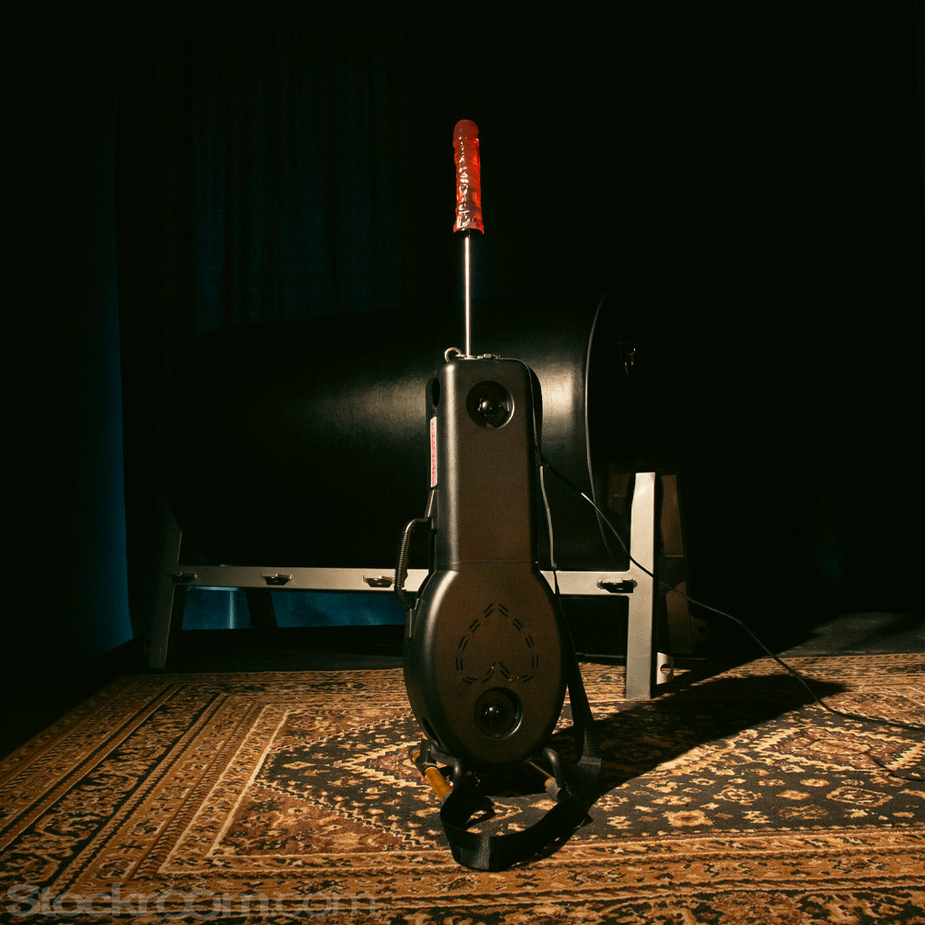 Product shot of the Shredder Fuck Machine sitting upright on a carpet, leaning against a spanking horse.
