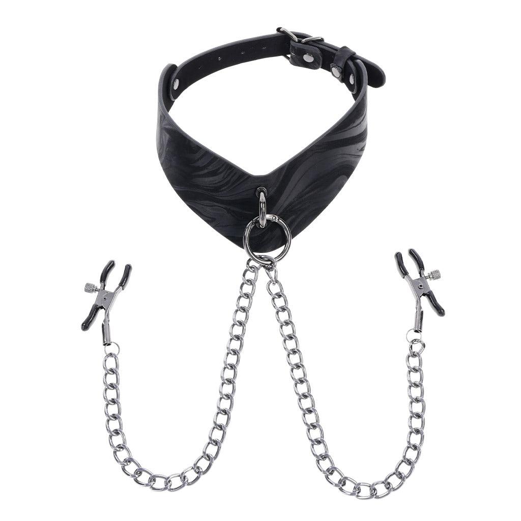 Product shot of the Velvet Noir collar against a white background. It's made of black patterned leather with a metal ring at the front. A chain with adjustable nipple clamps at either end is threaded through the ring.