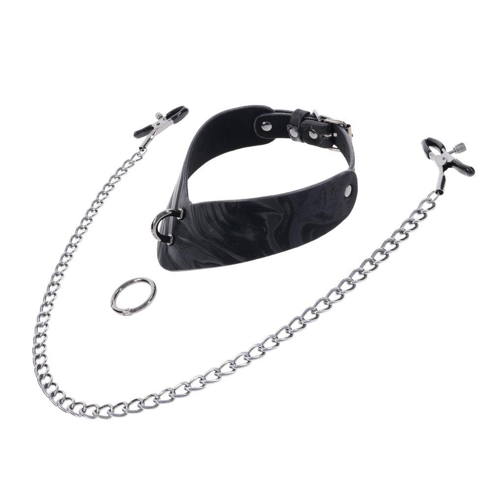 Product shot of the Velvet Noir collar
disassembled against a white background. In front of the collar is a metal ring and a set of nipple clamps on a long chain.