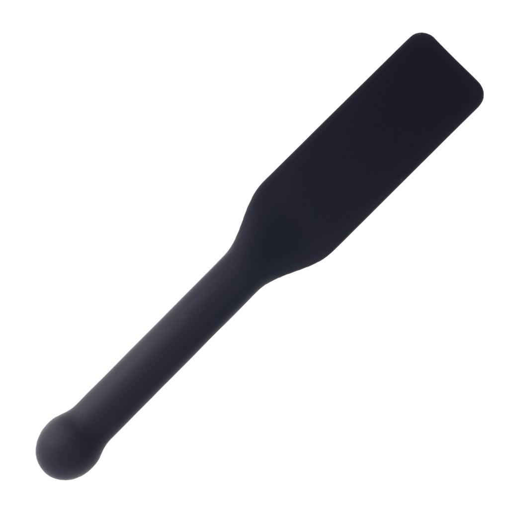 Full-size product shot of the Edge Silicone Paddle. The paddle is black with rounded corners and a long handle with a soft, round knob at the tip.