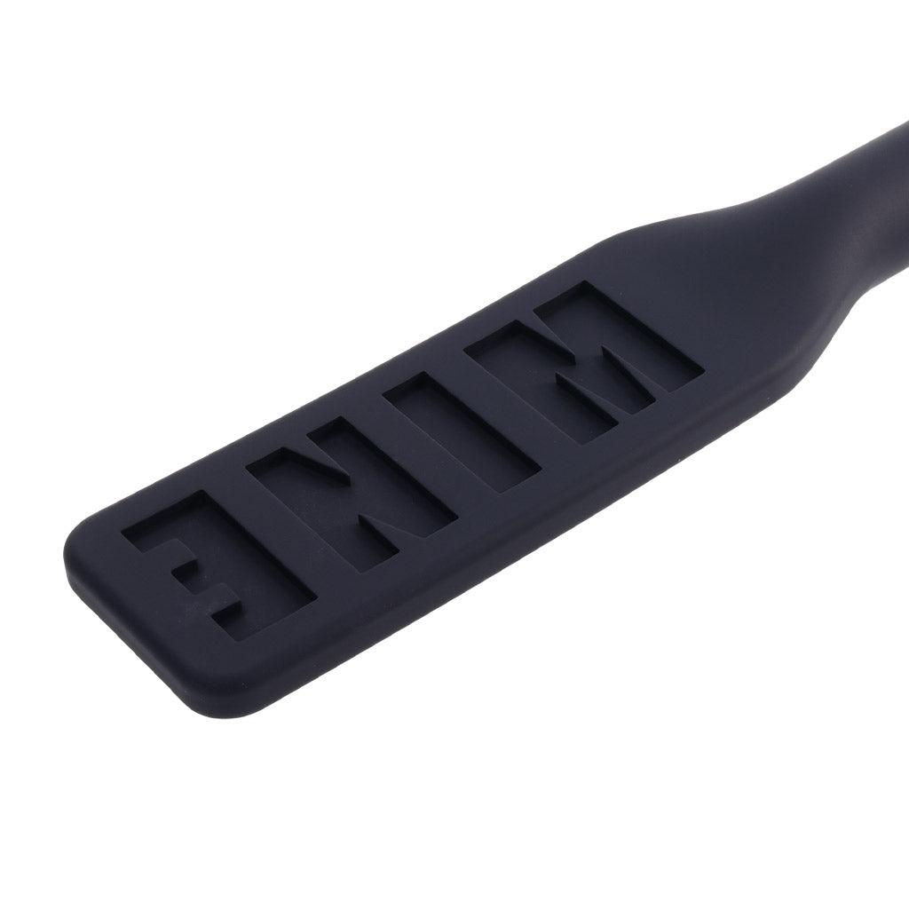 Closeup of the top of the Edge Silicone Paddle. In the surface, the word MINE is imprinted backwards.