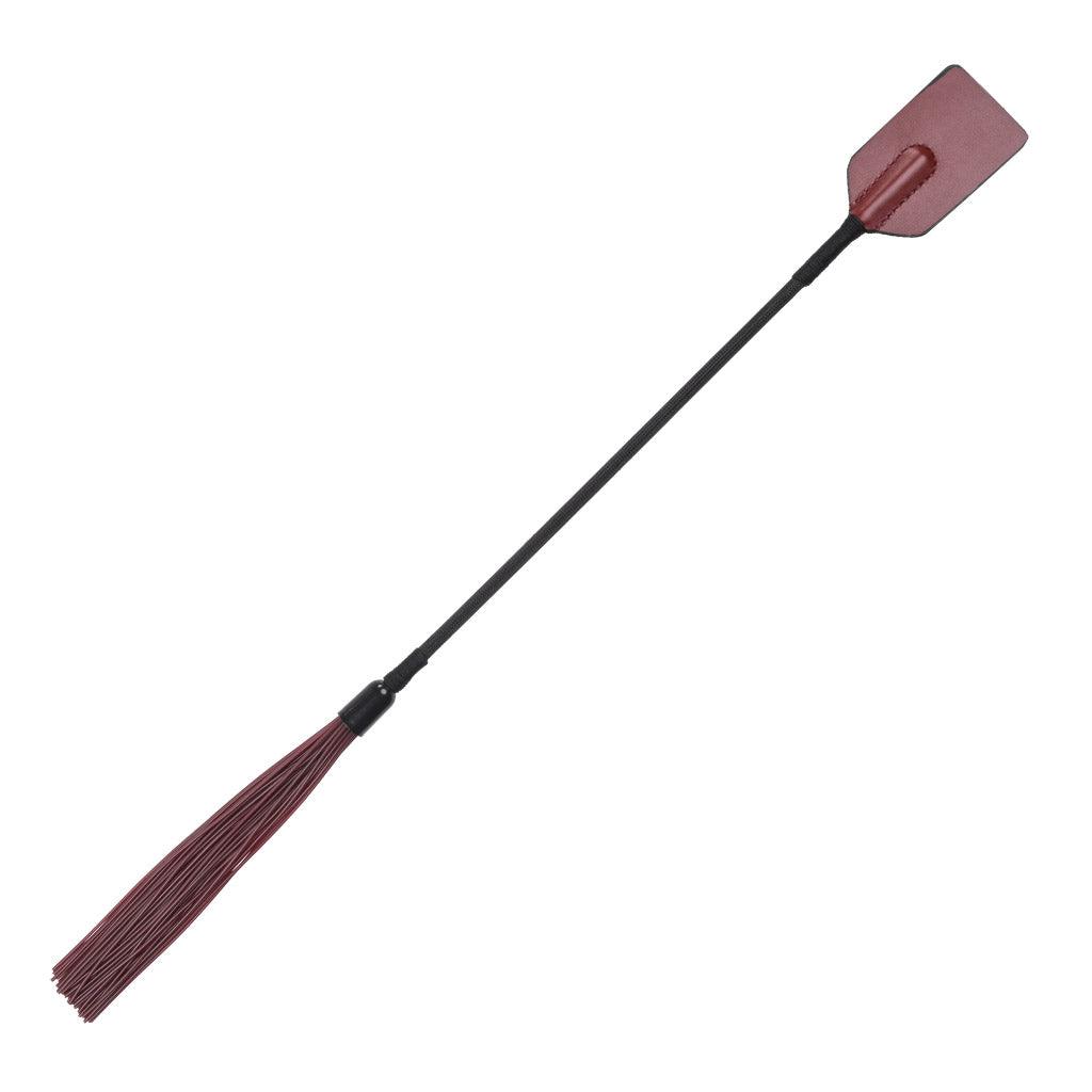 Full-size product photo of the Saffron Tap and Tickle Crop. At one end, it has the leather tongue of an ordinary riding crop; at the other are short, rubber falls used for light flogging.