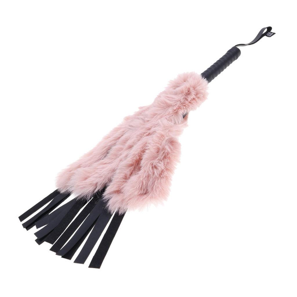 Full product photo showing a flogger with faux-leather falls, covered by soft pink fur.