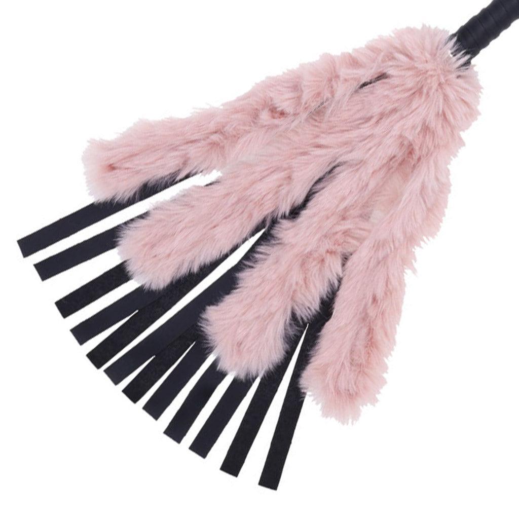 Close-up of theBrat Faux Fur Flogger, showing the falls spread apart for a clearer view, with the pink faux fur extending about halfway down.