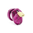 Load image into Gallery viewer, A short, stubby penis cage made of pink plastic shown on a white background. The plastic is covered with glitter, and a brass padlock keeps the top closed.