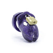 Load image into Gallery viewer, A medium-sized penis cage made of purple plastic shown on a white background. The plastic is covered with glitter, and a brass padlock keeps the top closed.