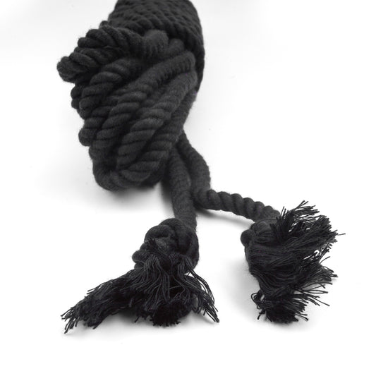 The knotted ends of the black bamboo silk rope is shown on a white background.