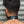 Load image into Gallery viewer, A close-up of the back of a brunette man’s neck is shown. He wears the Locking Leather Collar, which is locked shut with a brass padlock.
