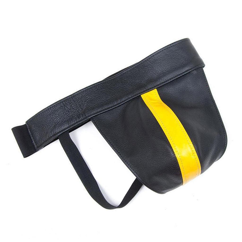The yellow Leather Color Coded Jockstrap is shown against a blank background. It is a black leather jockstrap with black elastic strips. There is a vertical strip of yellow leather in the center of the jock.