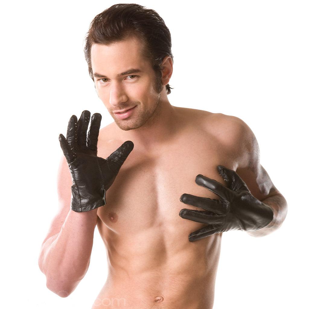 A shirtless man with brown hair wearing Vampire Gloves is shown against a blank background. One of his hands rests on his chest. The other hand is raised with his palm turned towards the camera, showing the spikes on the glove.