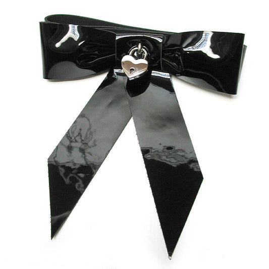 A large bow made of shiny black patent leather with a silver heart-shaped padlock in the center.