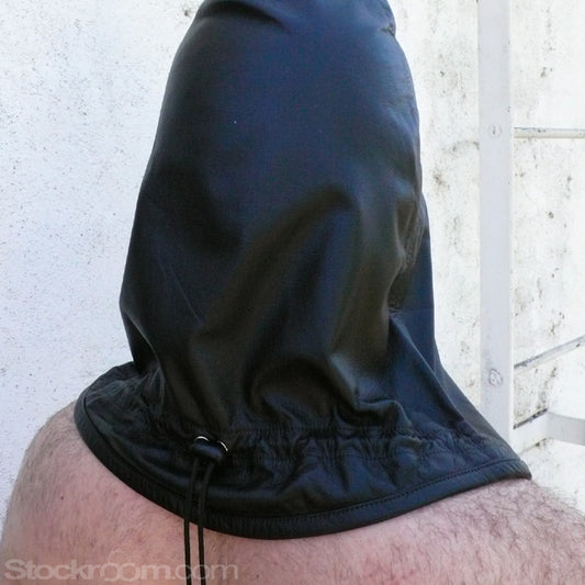 A man standing against a white wall is shown from behind, wearing the Leather Guillotine Hood. The base of the hood hits the top of his back. There is an adjustable drawstring cord near the base of the hood.
