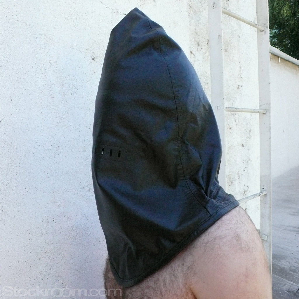 A side shot of a man standing against a white wall is shown, wearing the Leather Guillotine Hood. The base of the hood hits the top of his back.