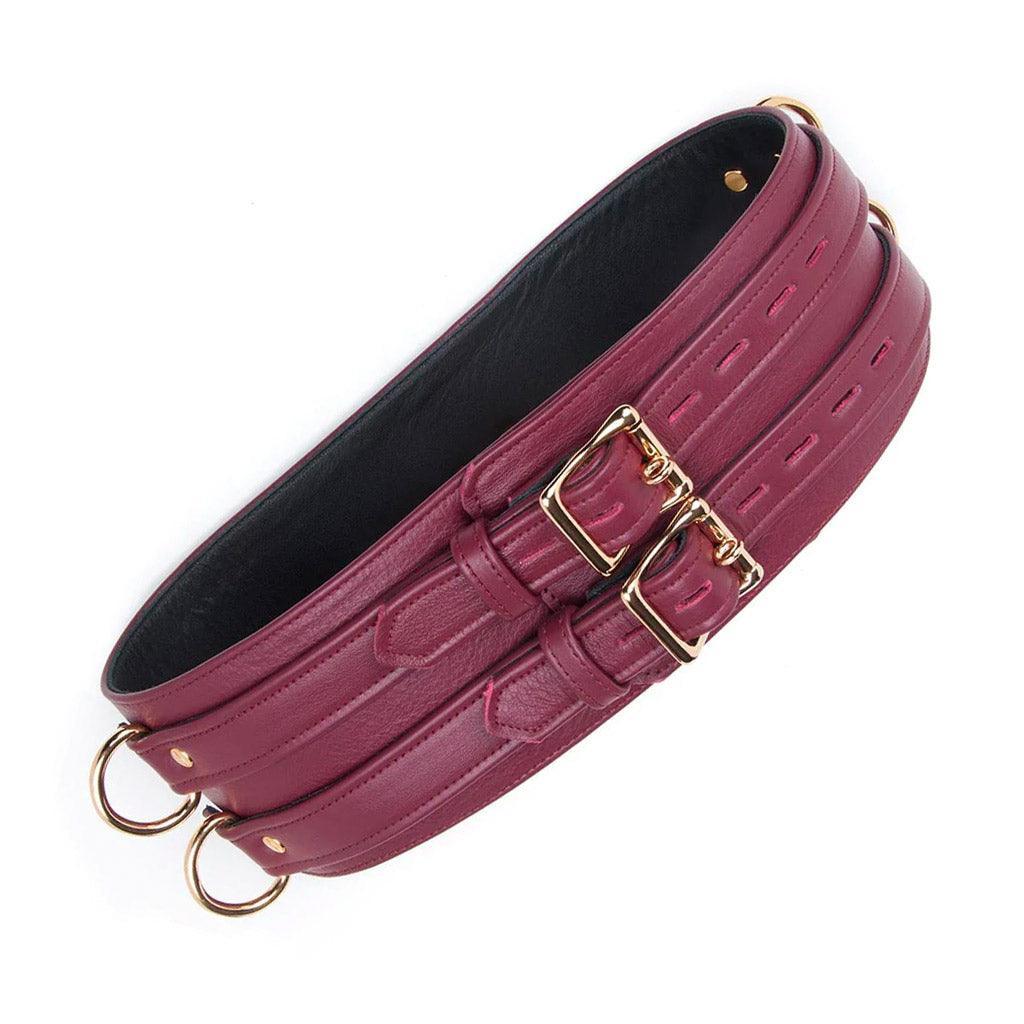 The JT Signature Collection Leather Waist Cuff is shown from the front against a blank background. It has two adjustable straps that fasten with gold lockable buckles. The interior lining of the leather is black.