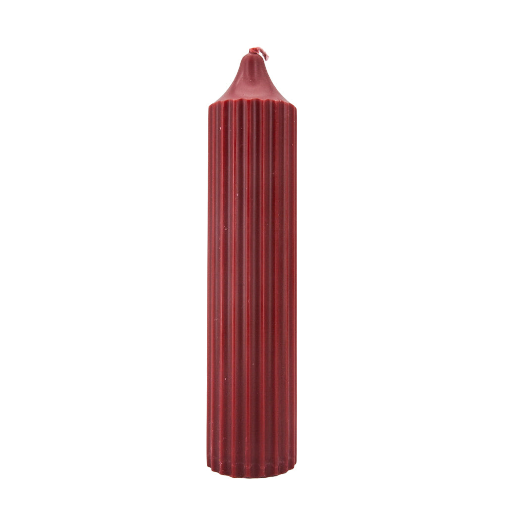 The red scented was play drip candle is shown against a white background.