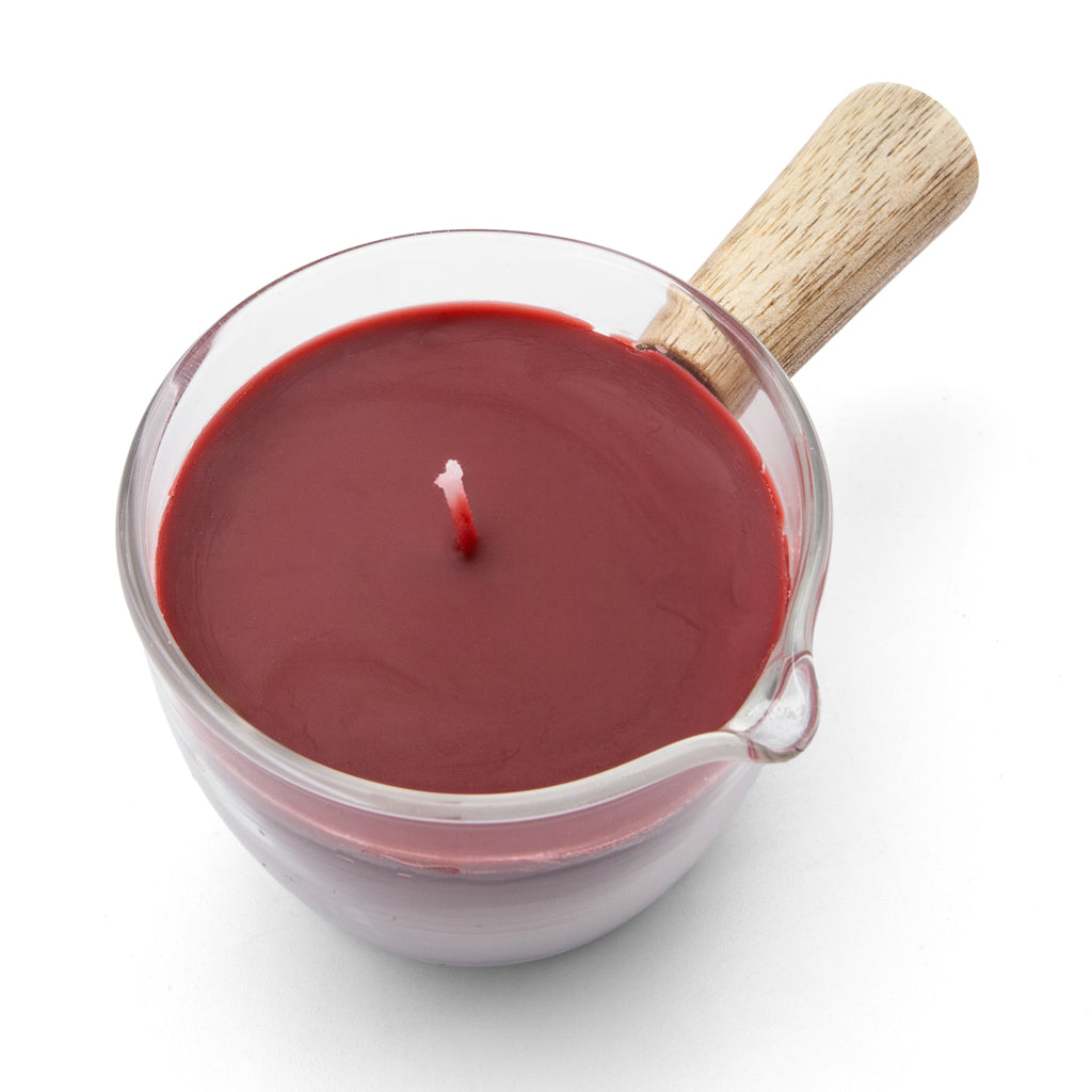 A top view of the easy pour wax play candle with wooden handle is shown on a white background.