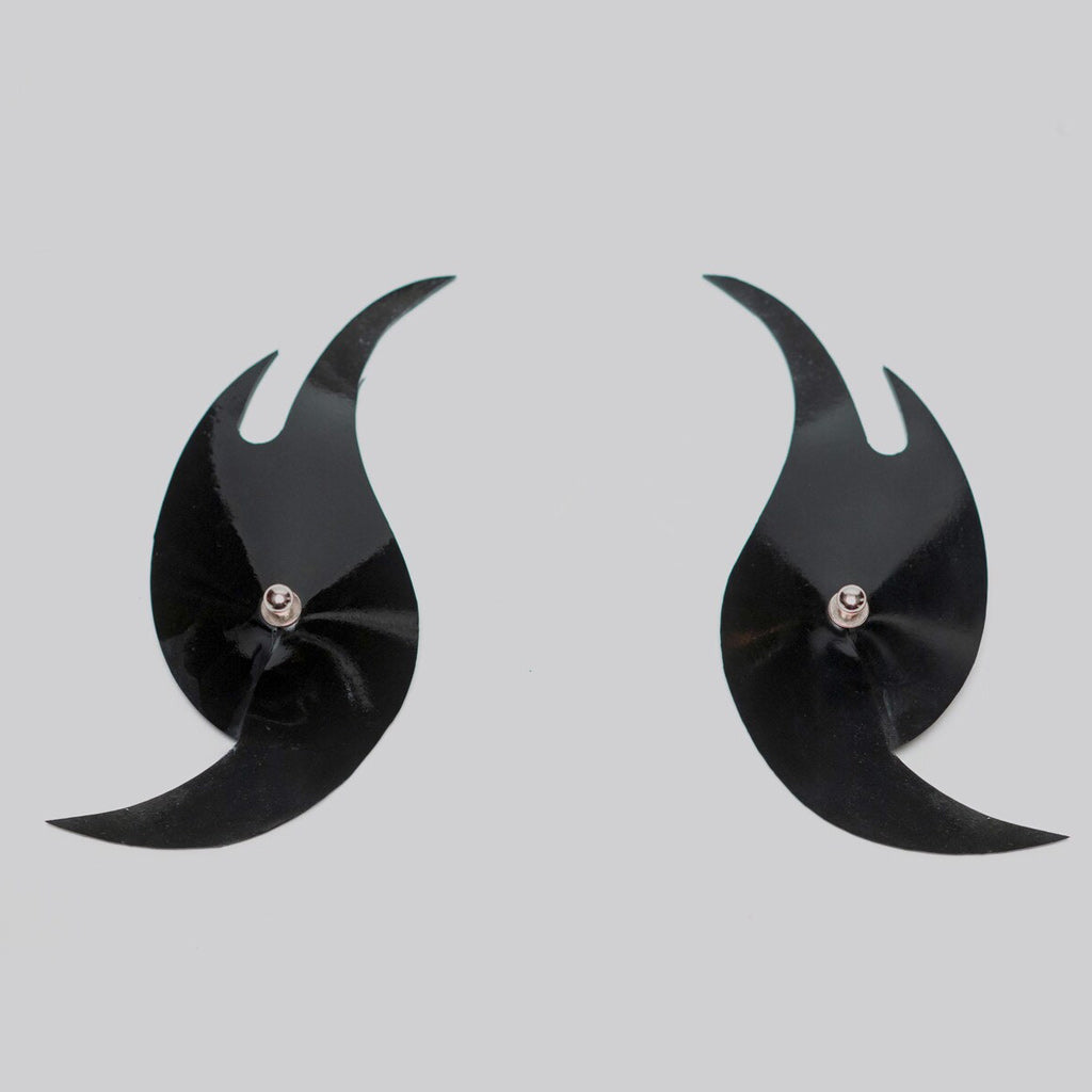 Pair of black wing-shaped pasties on a light gray background