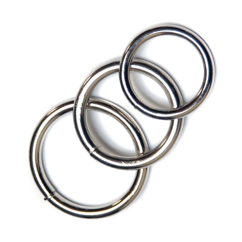 The kinklab steel cock ring 3 pack set is shown spread out with the rings overlapping each other on a white background.
