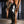 Load image into Gallery viewer, A man wearing the black Rubber Sleepsack is shown chained to a wooden beam. The Sleepsack covers his entire body, excluding his head. There is a collar around his neck and a zipper running down the middle of his body.
