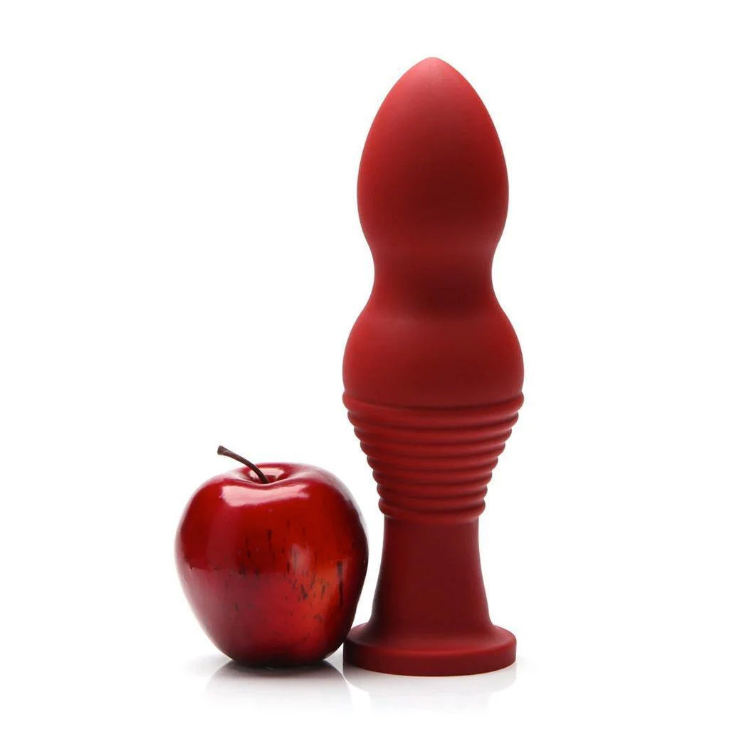 The red tantus Piggy XL Silicone Dildo is shown next to a red apple against a white background.