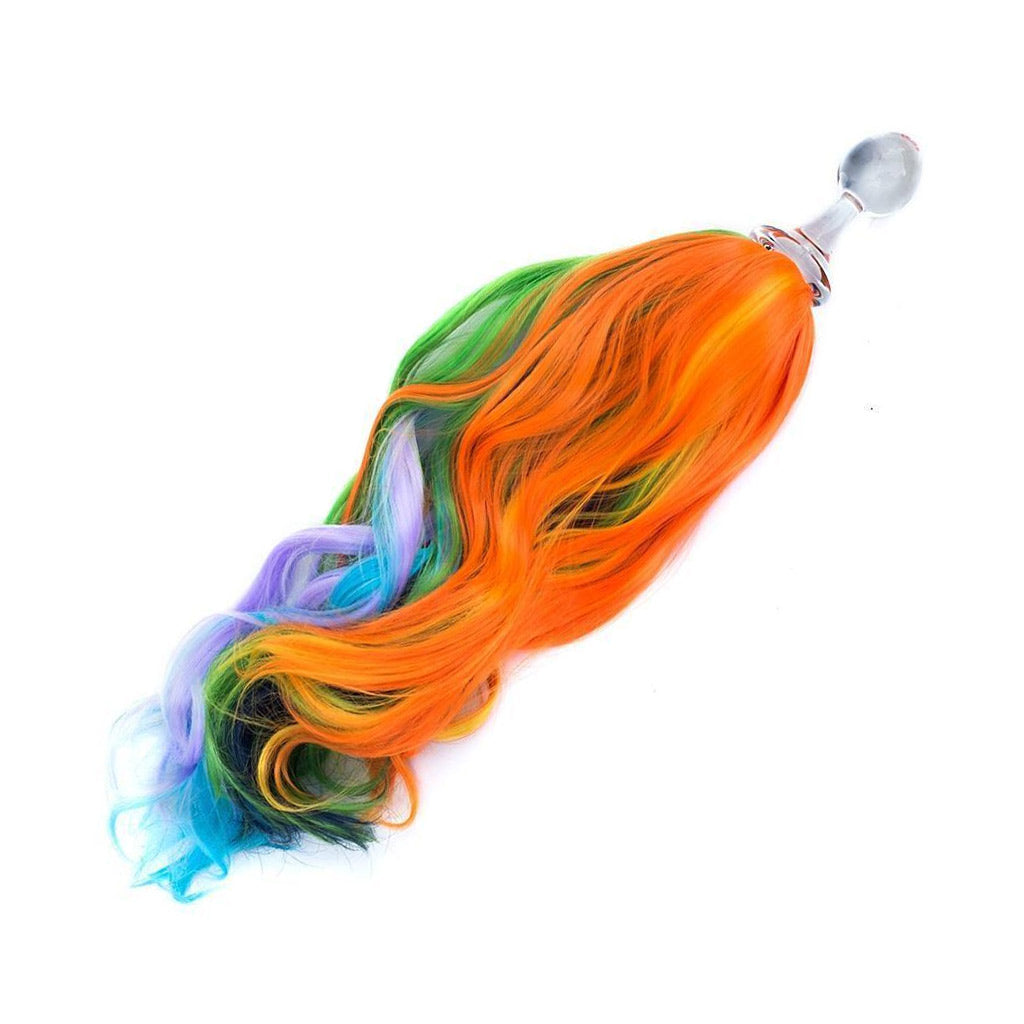 The Rainbow Detachable Ponytail Glass Butt Plug is shown against a blank background. The plug is made of clear glass and has a long tail of multi-colored hair attached to the base.