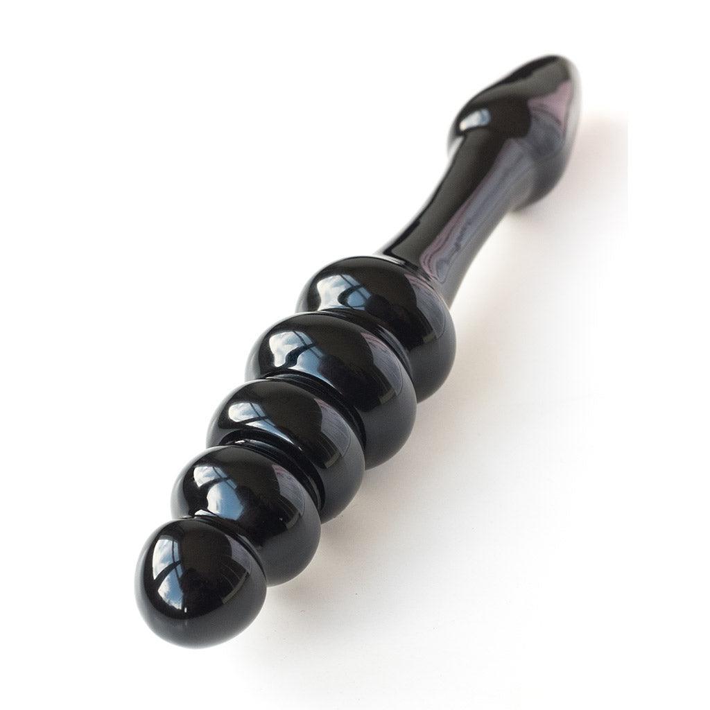 The Black Arrow glass dildo, viewed from the base looking up the shaft toward the tip.