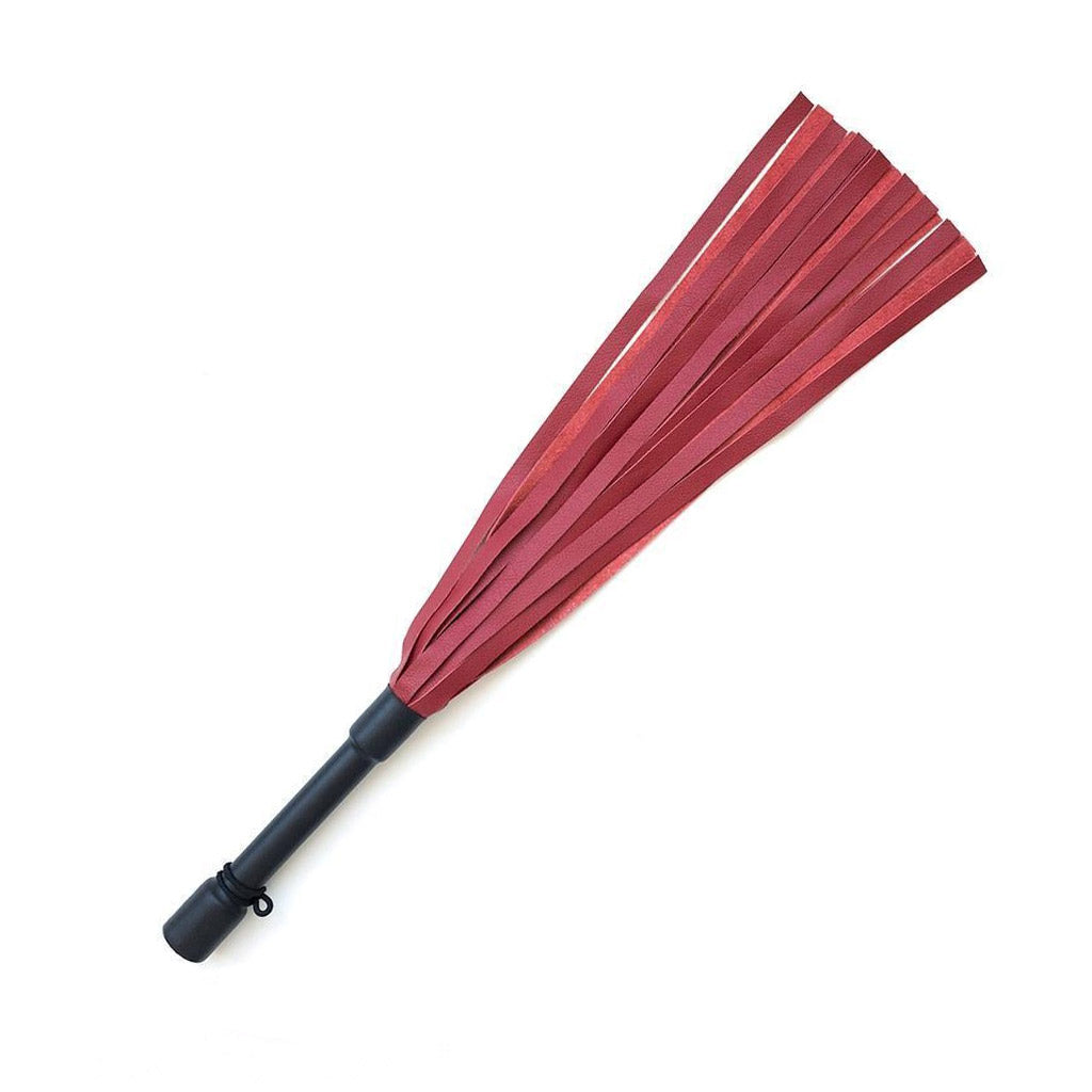 The Red Devil Leather Flogger By Dragontailz is displayed against a blank background. The flogger has falls that are dark red on one side and lighter red on the other, as well as a black handle.