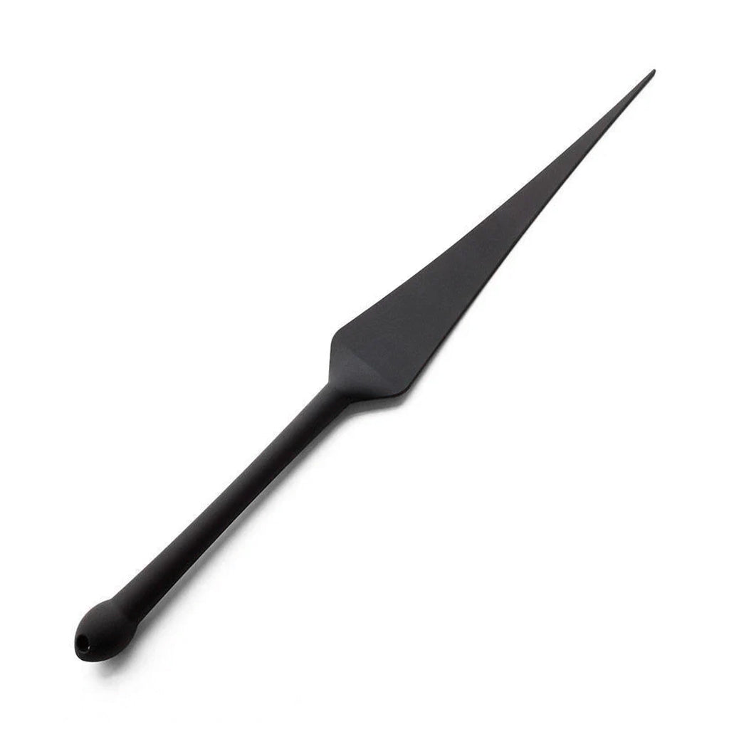 The Tantus Silicone Dragon Tail, made of matte black silicone, is displayed against a blank background. It has a flat, triangular top and a cylindrical handle with a bulbous end.