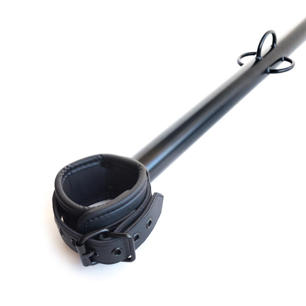 The black Big Barrel 12 Inch Wrist Spreader Bar With Cuffs is displayed against a blank background.