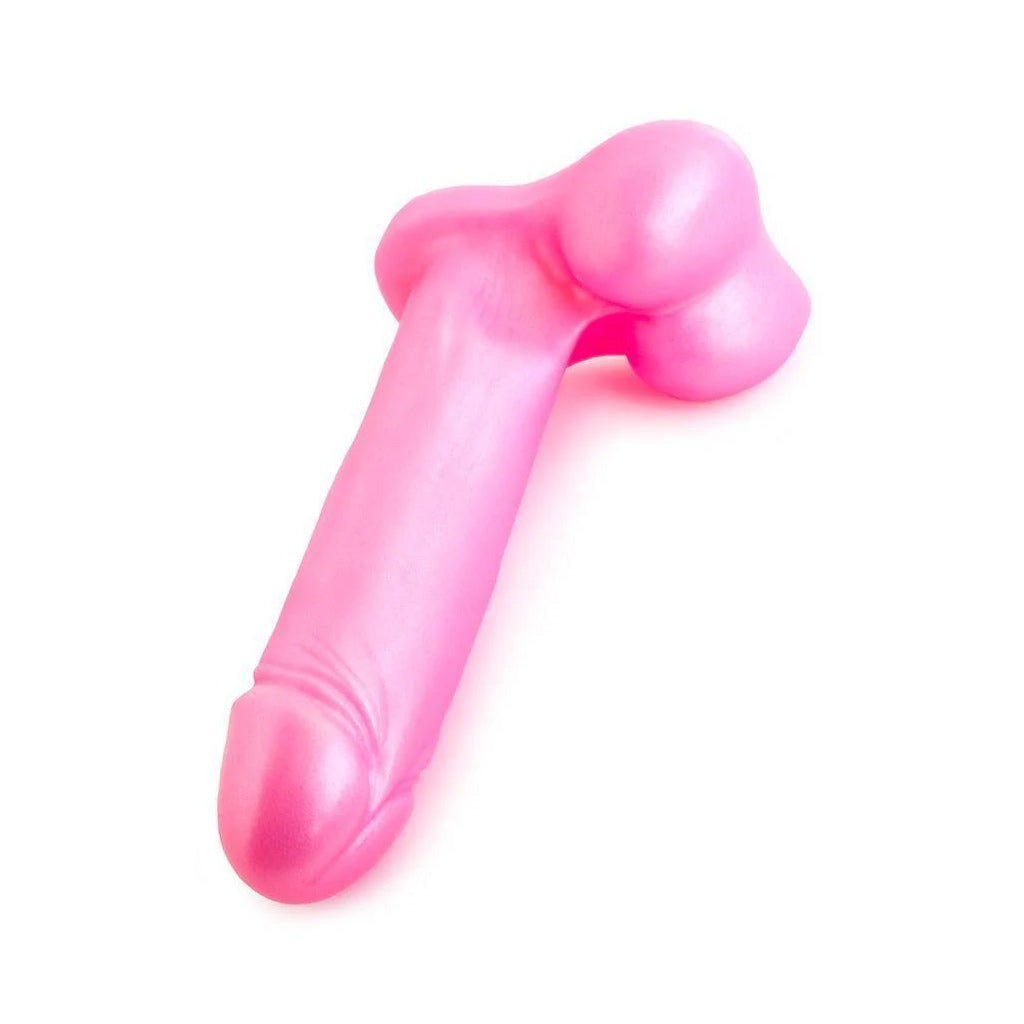 The Tantus Champion Dildo lying on a white surface, the tip pointed at the viewer.