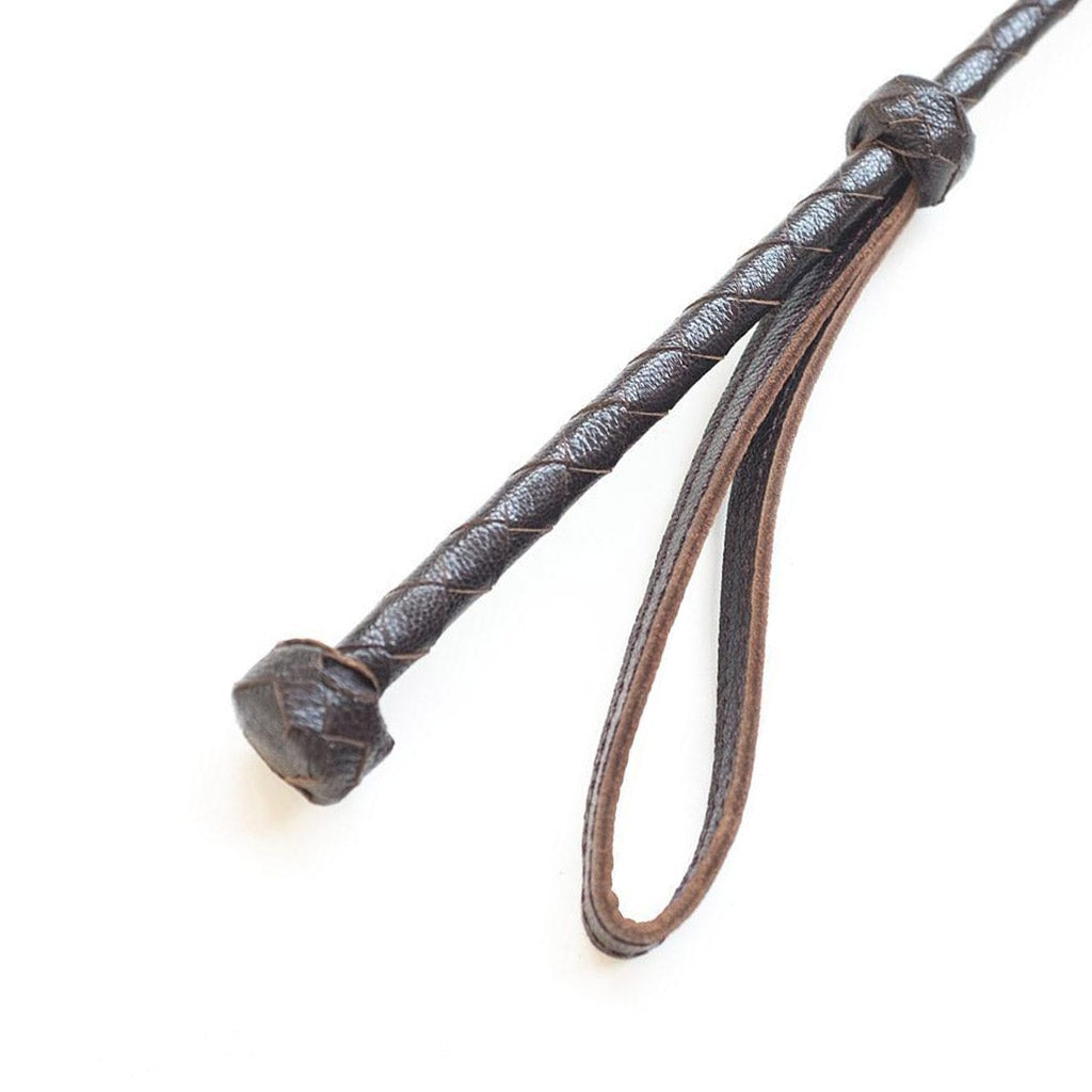 A close-up of the Brown Leather Heart Crop handle is displayed against a blank background, showing the wrist loop.