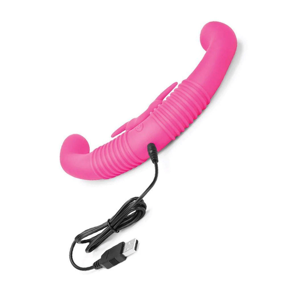 The together™ Couples Vibrator is shown from the back with its charing cable plugged in.